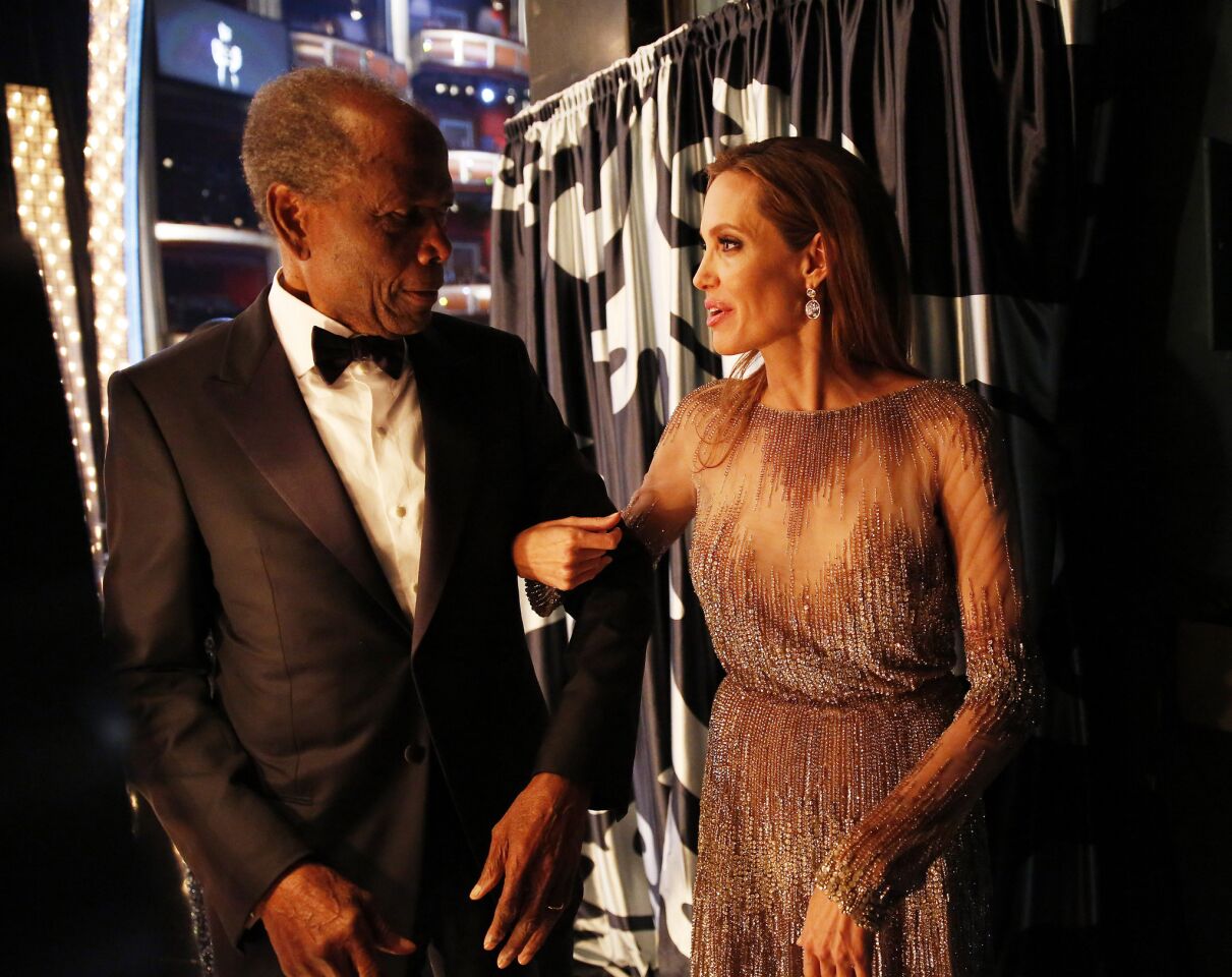 Legendary actor Sidney Poitier and actress Angelina Jolie chat backstage. Jolie was the recipient of the 2014 Jean Hersholt Humanitarian Award.