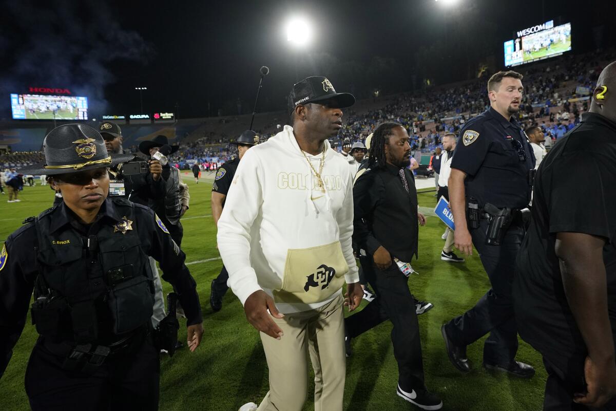 Colorado coach Deion Sanders walks off the field after a 28-16 loss to UCLA at the Rose Bowl on Saturday.