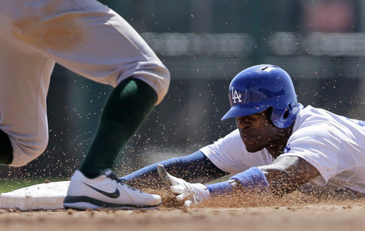 Dodgers' Yasiel Puig steals second base during a spring training game against the Oakland Athletics.