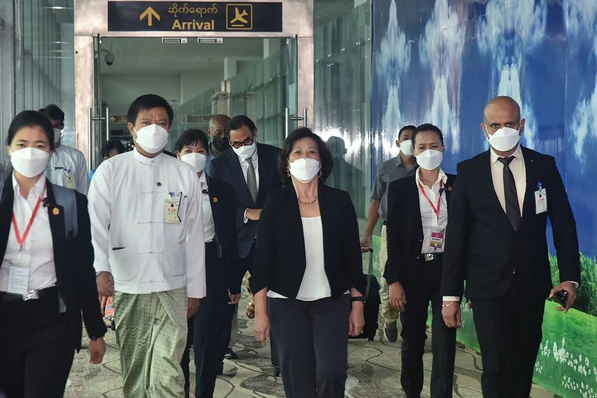 In this image provided by the Military True News Information Team, United Nations special envoy Noeleen Heyzer, center, arrives at the Yangon International Airport, Tuesday, Aug. 16, 2022, in Yangon, Myanmar. Heyzer arrived in Myanmar Tuesday on her first mission to the country since her appointment last year, making her visit in the wake of a recent call by the world body’s Security Council for an immediate end to all forms of violence there and unimpeded humanitarian access to aid those affected by the strife. (Myanmar True News information Team via AP)