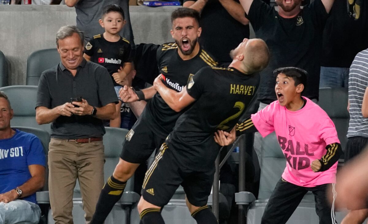LAFC forward Diego Rossi, left, celebrates with defender Jordan Harvey after scoring during a 5-3 playoff win over the Galaxy on Thursday.