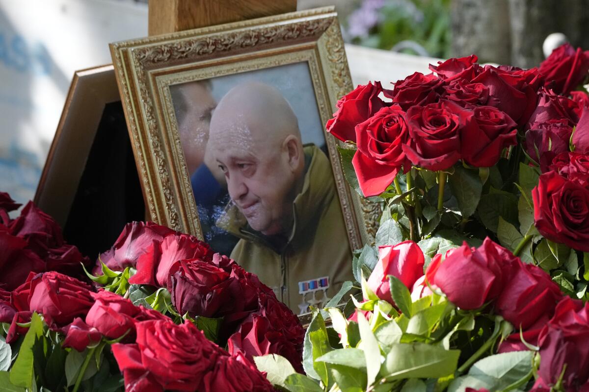 Portrait of  Yevgeny Prigozhin among flower bouquets