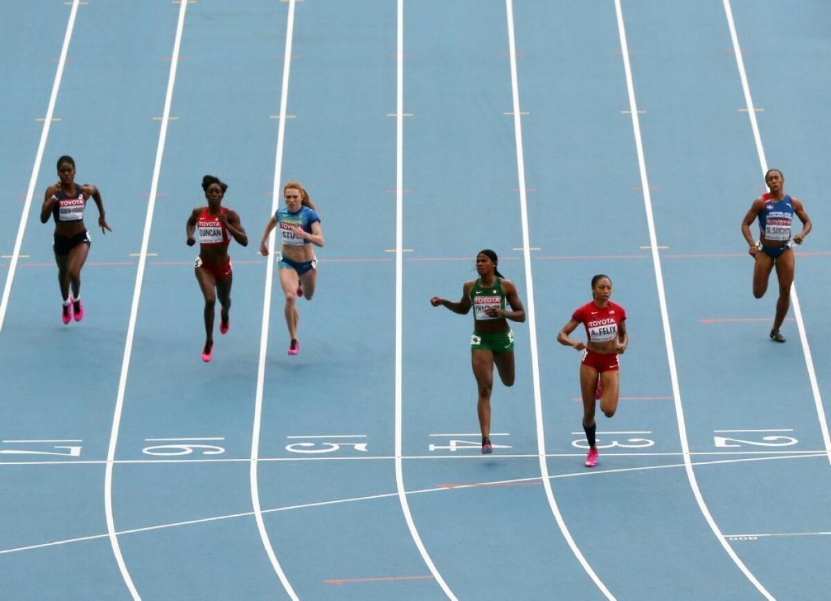 Allyson Felix leads the pack in the 200-meters semifinal race.