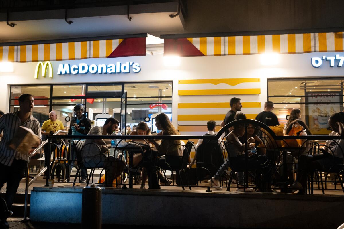 People sit at McDonald's outdoor seating in Tel Aviv, Israel. 