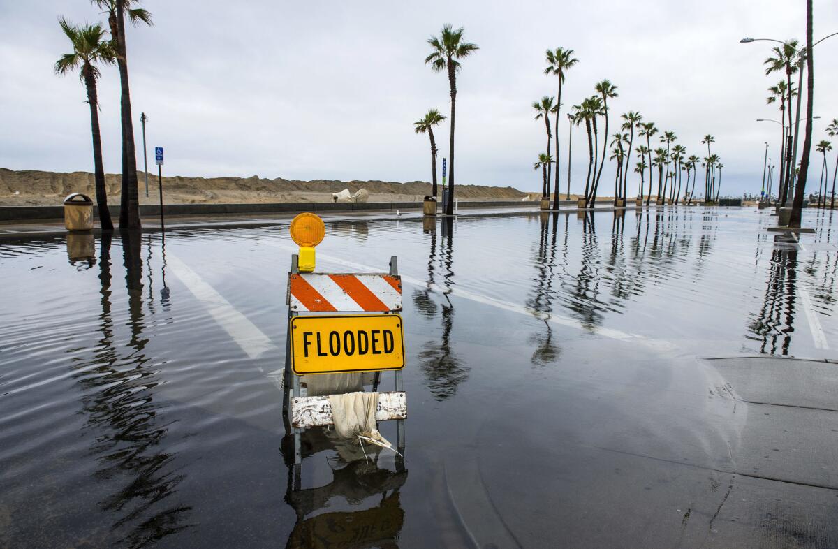 Street sign in a flooded Balboa Island parking lot