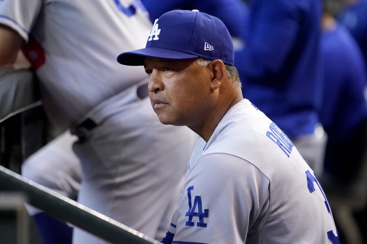 Los Angeles Dodgers manager Dave Roberts watches play during the second inning of a baseball game against the Arizona Diamondbacks, Saturday, May 28, 2022, in Phoenix. (AP Photo/Matt York)