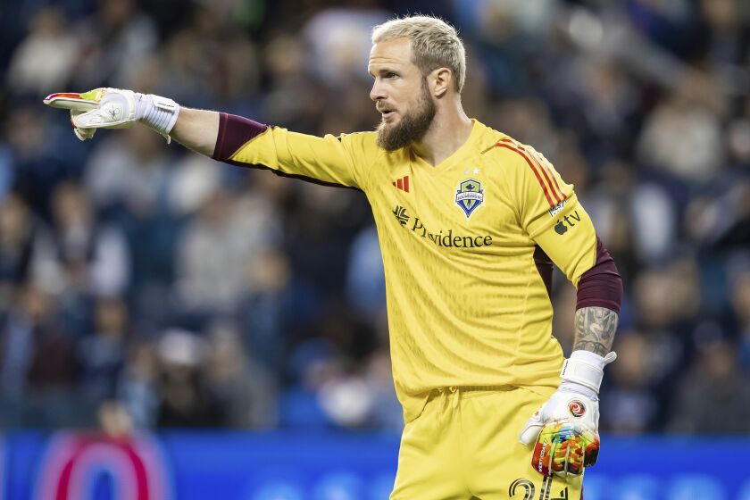 Seattle Sounders goalkeeper Stefan Frei (24) directs his team on a free kick during the second half of an MLS soccer match against Sporting Kansas City, Saturday, March 25, 2023, in Kansas City, Kan. (AP Photo/Nick Tre. Smith)