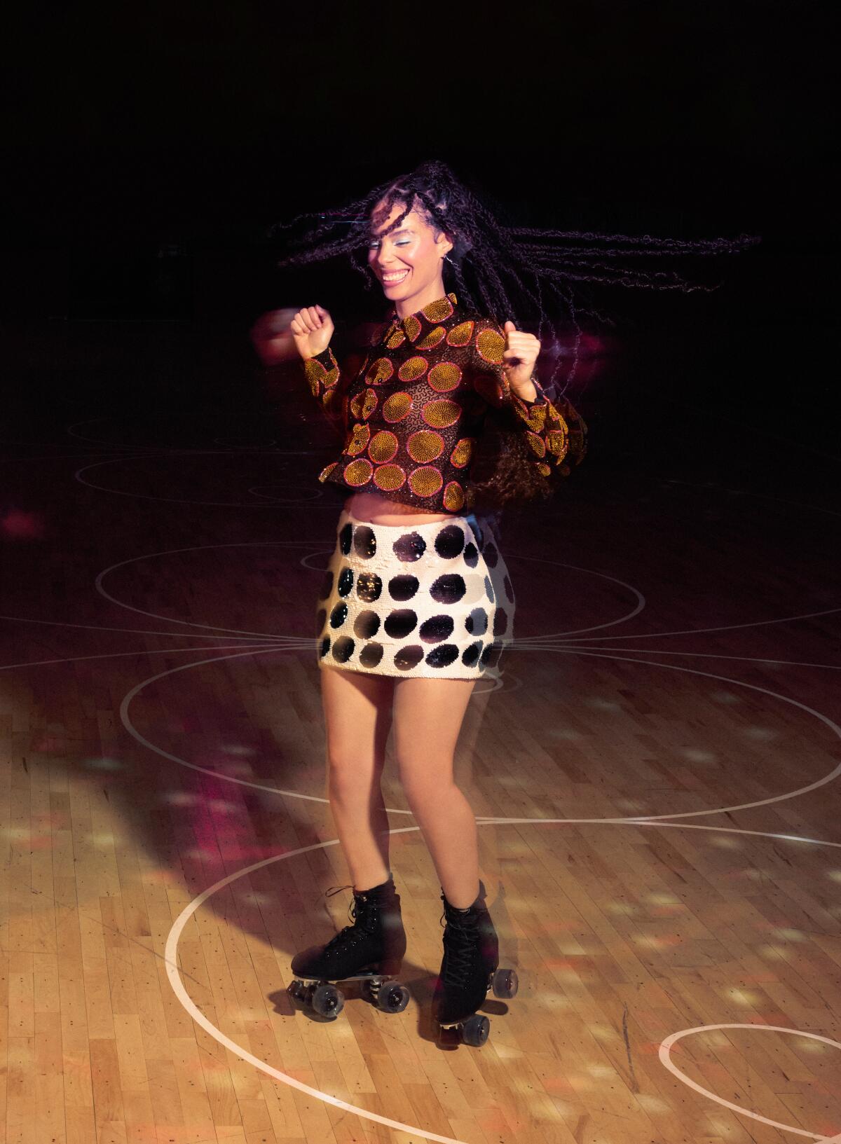 A woman poses for a photo while rollerskating