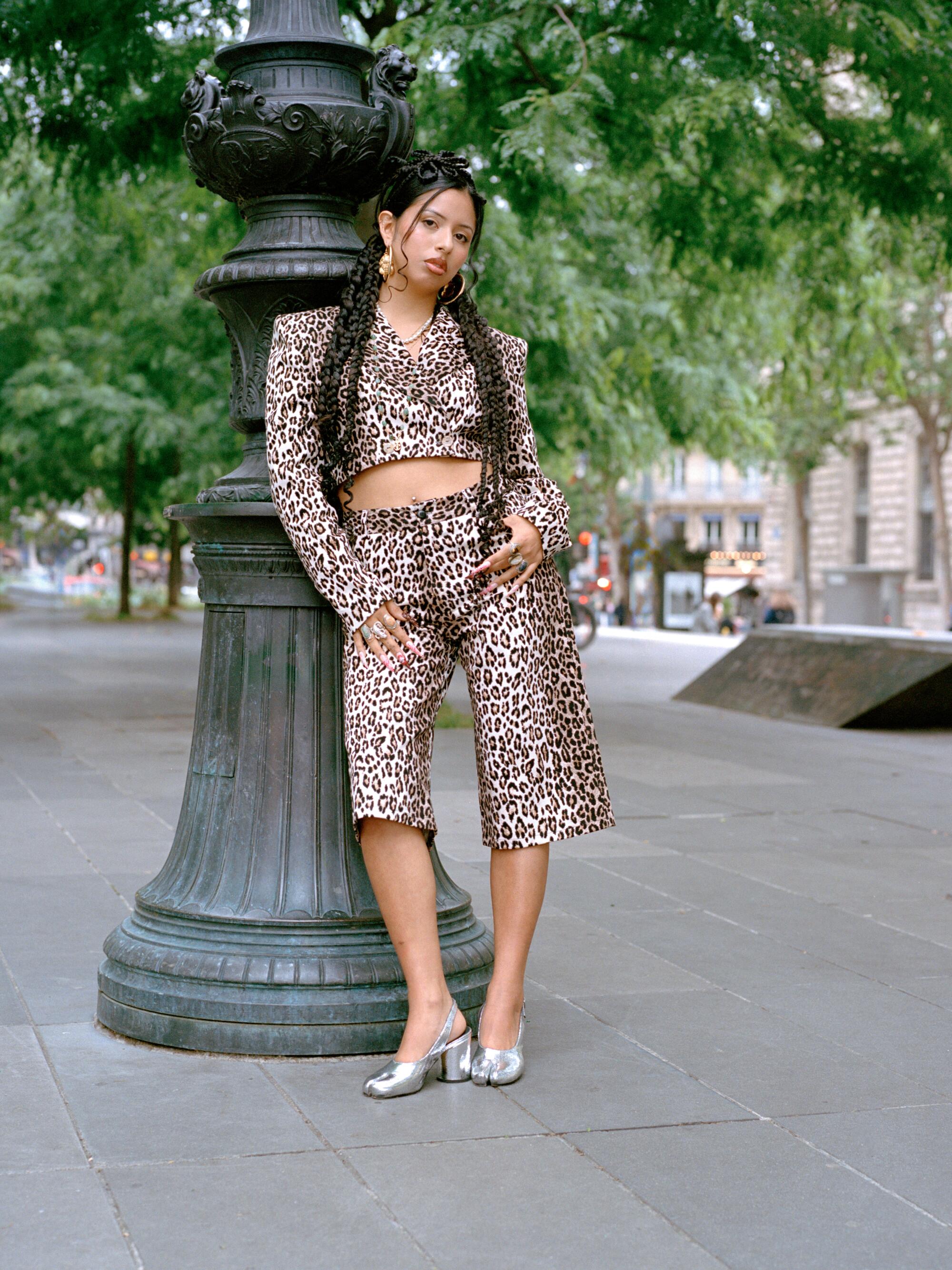 Claudia wears Roberto Sanchez animal print suit, Maison Margiela Tabi shoes, Shilita Créations jewelry.