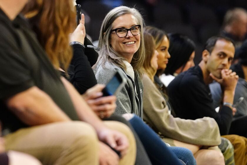 Arizona Governor-elect Katie Hobbs enjoys an NBA basketball game between the Phoenix Suns and Washington Wizards in Phoenix, Tuesday, Dec. 20, 2022. (AP Photo/Darryl Webb)
