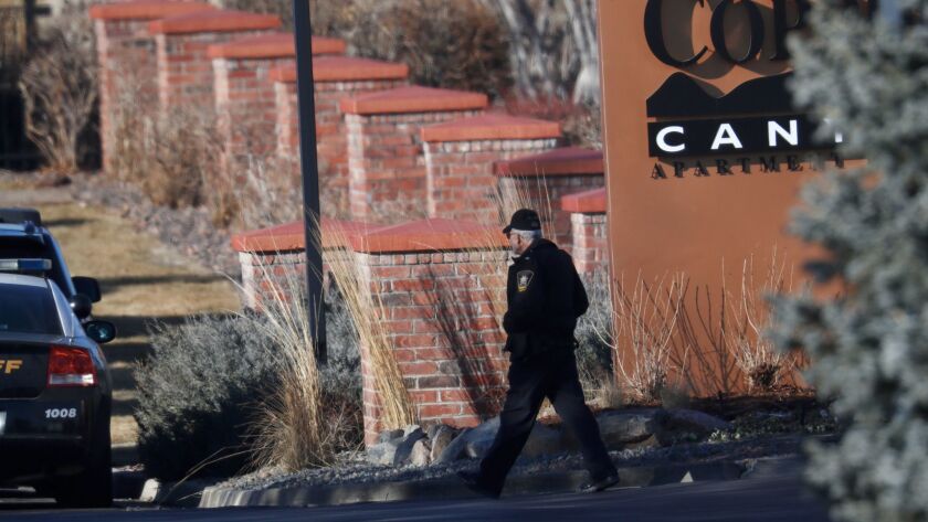 An investigator heads to the scene of the shooting Sunday in Highlands Ranch, Colo.