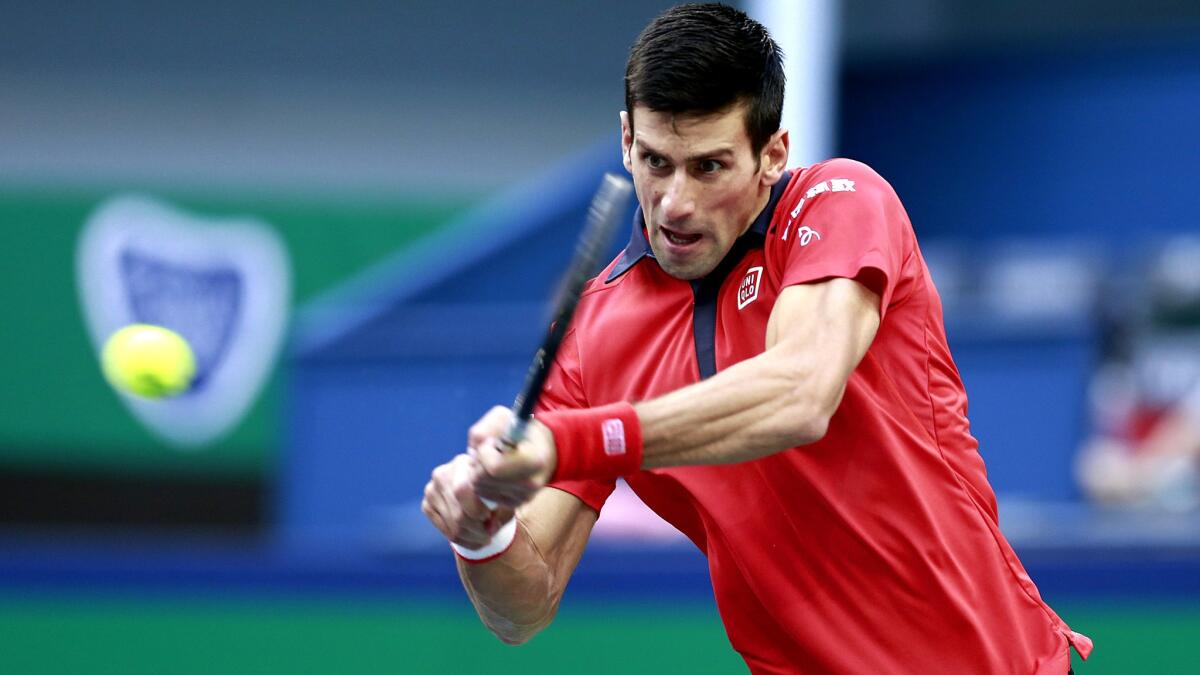 Novak Djokovic returns a shot against Jo-Wilfried Tsonga Shanghai Rolex Masters championship match on Sunday.