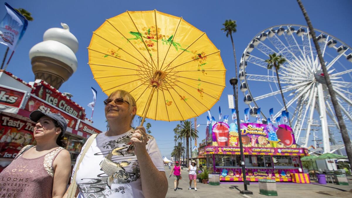 Danica Paz, left, of Sherman Oaks, and Amy Barer, of Los Angeles, arrive early at the Fairplex to beat beat the crowds on the first day of the Los Angeles County Fair in Pomona, Calif., on Aug. 31.