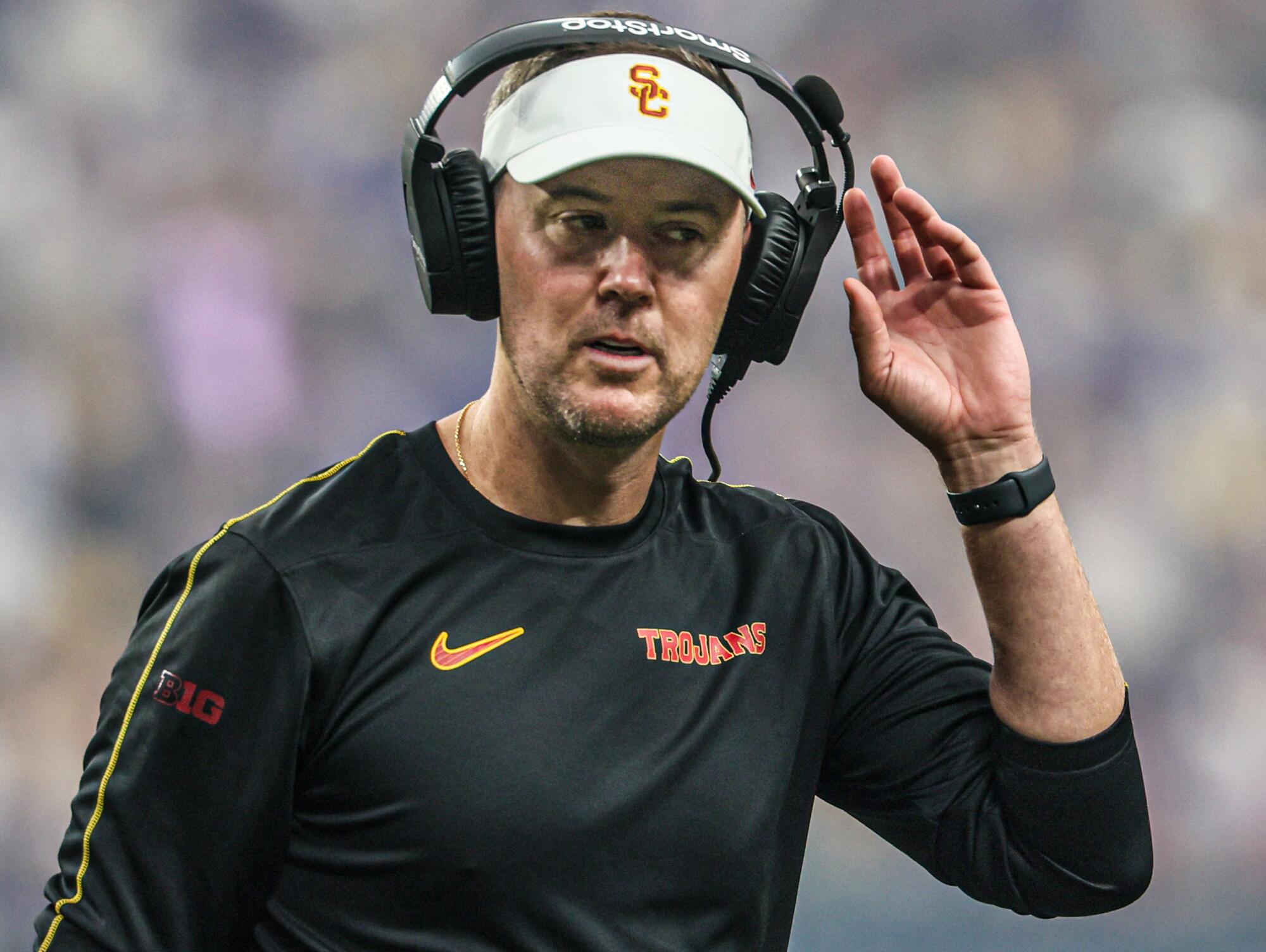 USC coach Lincoln Riley walks on the sideline.