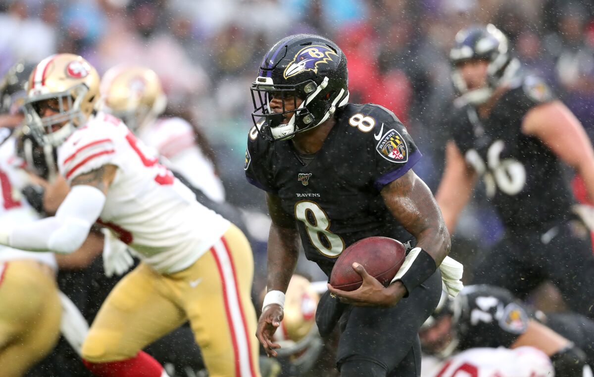 Baltimore Ravens quarterback Lamar Jackson runs for a first down.