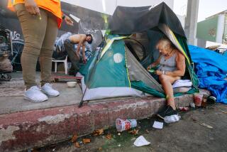 Sherri Oller, right, gathers her belongings and one of Mayor Karen Bass' Inside Safe program.