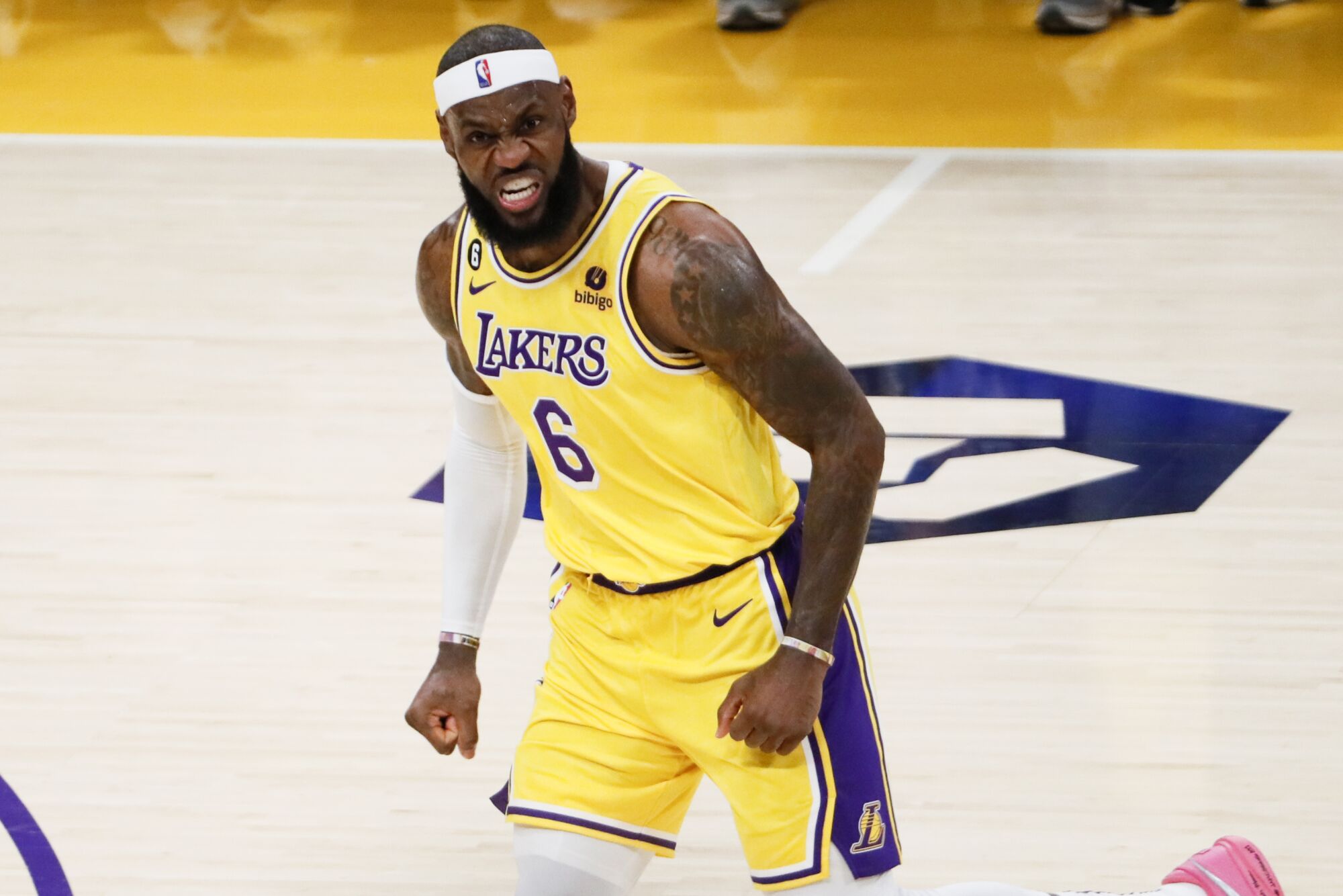 Los Angeles Lakers forward LeBron James sneers after making a three-point shot in the third quarter.