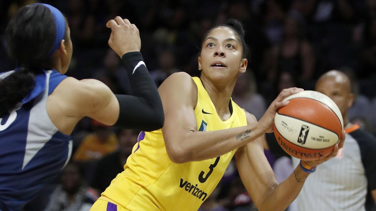Sparks center Candace Parker shoots against Lynx forward Maya Moore in the first quarter of the WNBA semifinals on Aug. 21.