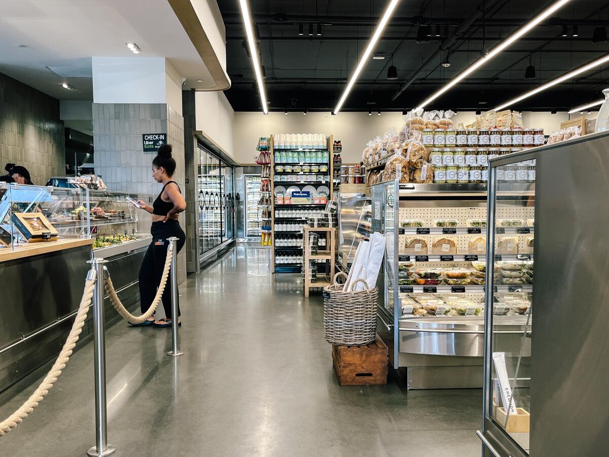 A customer orders from the cafe at Erewhon in Culver City in July.