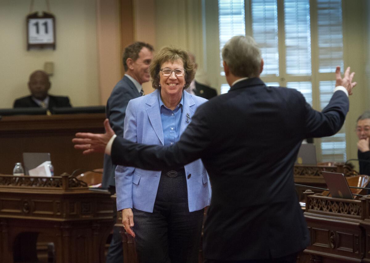 Sen. Lois Wolk, D-Davis, and Sen. Bill Monning, D-Monterey, celebrate after the passage of legislation which would allow terminally ill patients to legally end their lives at the state Capitol on Sept. 11.