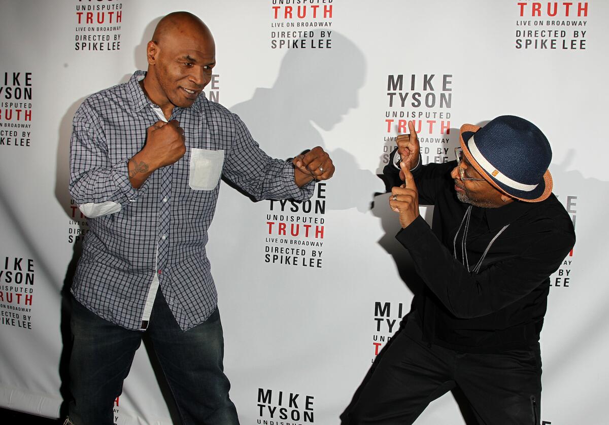 Mike Tyson, left, and director Spike Lee kid around backstage at a "Mike Tyson: Undisputed Truth" event last summer.