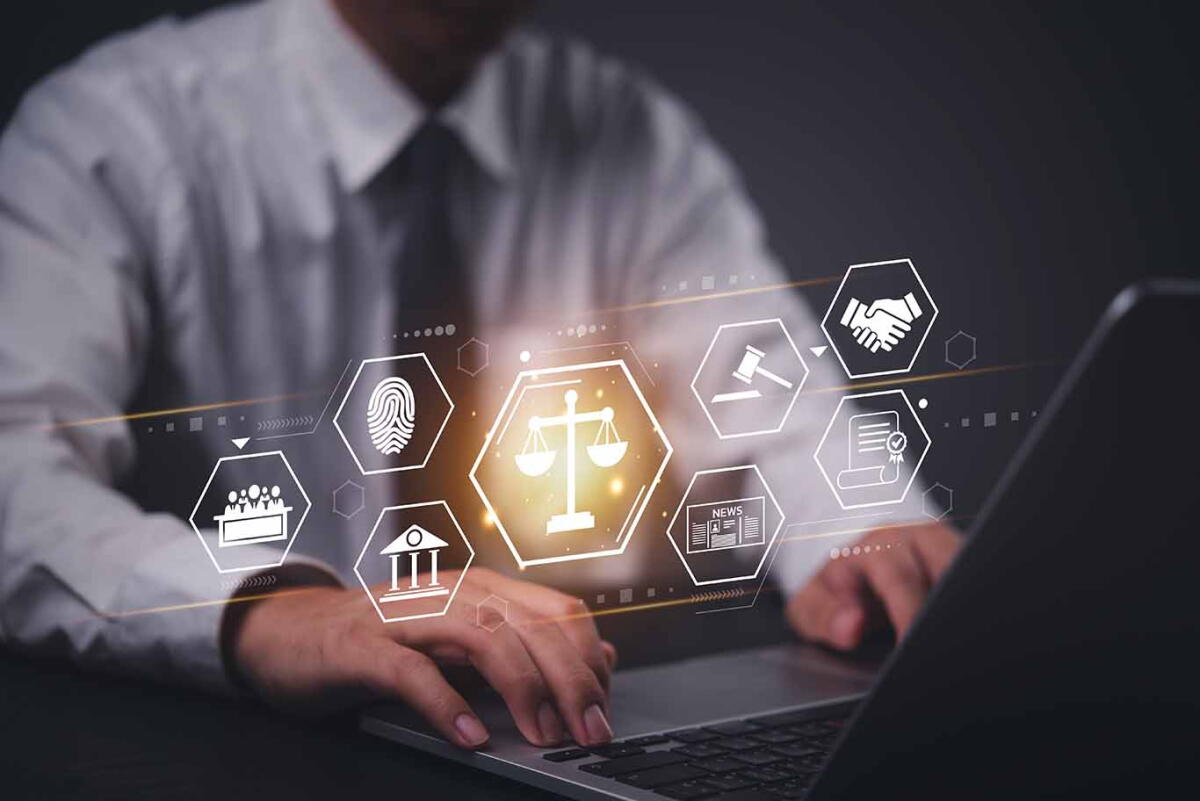 Businessman using a laptop with a digital law and justice interface