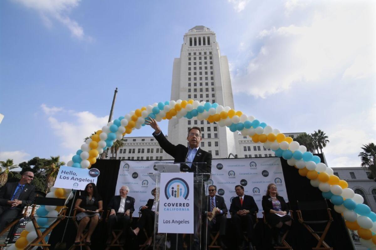 Covered California's executive director, Peter Lee, discusses the launch of open enrollment in downtown Los Angeles on Nov. 14 during a statewide bus tour.