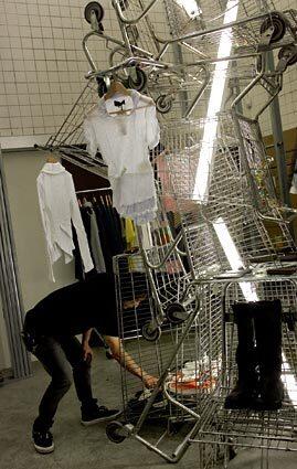 A sculpture of old grocery carts defines the decor inside Comme des Garçons.