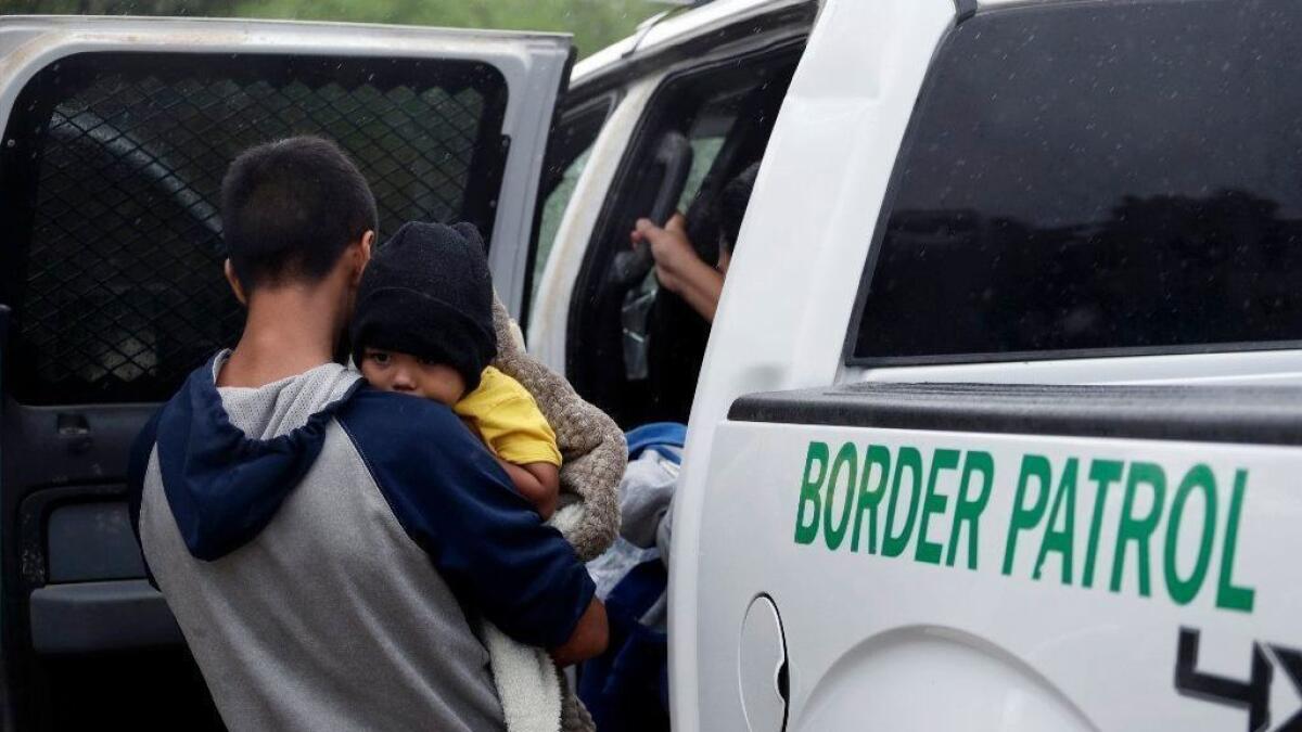Migrants who crossed the U.S.-Mexico border near McAllen, Texas, are placed in a Border Patrol vehicle.