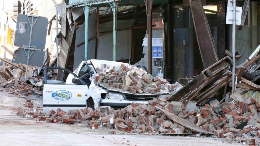 A taxi sits under fallen brick on Manchester Street after an earthquake shook central Christchurch, New Zealand, on Sept. 4, 2010.