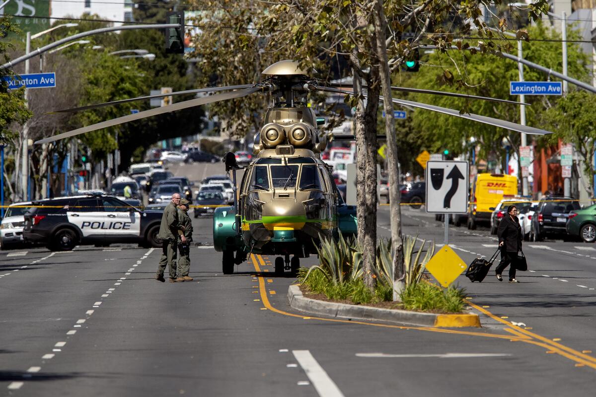 A sheriff's helicopter is parked on La Brea Ave. after dropping off  SWAT team.