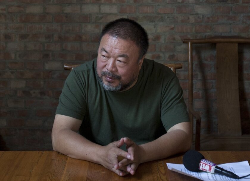 Artist Ai Weiwei speaking to journalists at his Beijing studio in May.
