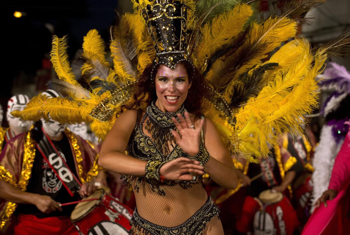 A dancer performs along a street in Montevideo's Sur neighborhood on the first night of the Llamadas (Calls) carnival parade. The Llamadas is Uruguay's biggest carnival parade, in which groups of dancers and drummers compete over the course of two nights.