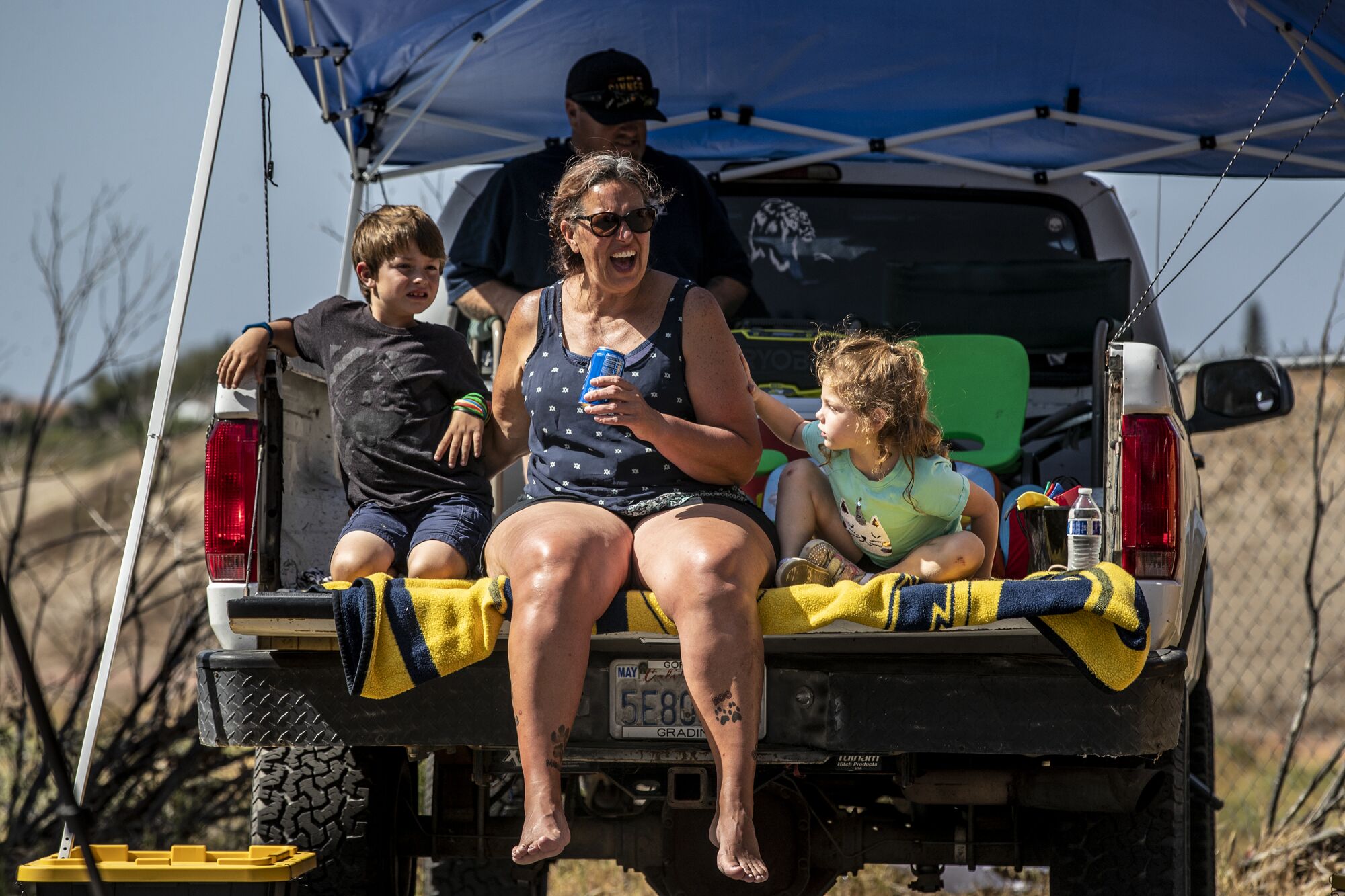  Dawn Sabatino and family cheer on wrestlers from the back of their pickup truck. 