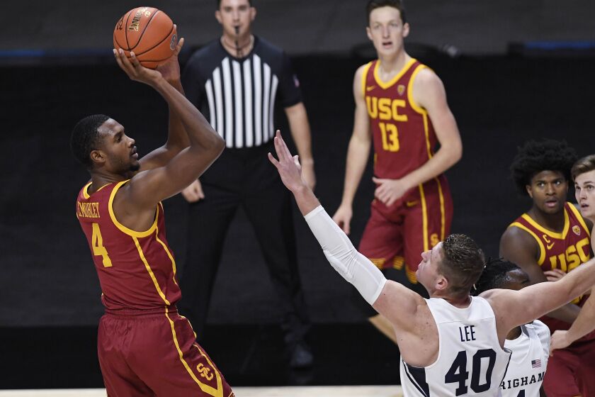 Southern California's Evan Mobley, left, shoots over BYU's Kolby Lee in the first half.