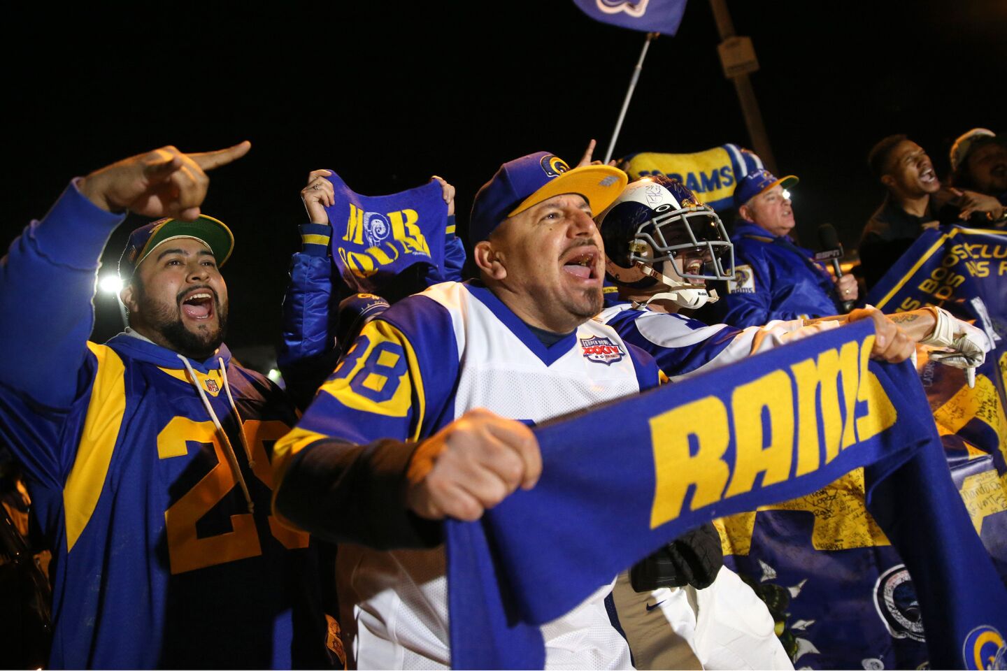 Alfredo Prieto, center, joins dozens of other Rams fans at Hollywood Park on Jan. 12 to celebrate the team's homecoming.