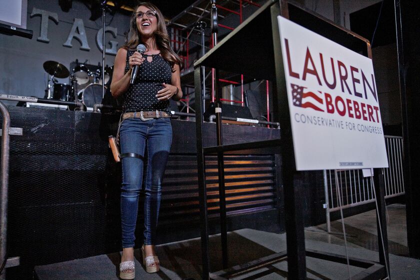 FILE - Businesswoman Lauren Boebert speaks during a watch party at Warehouse 25 Sixty Five in Grand Junction, Colo., after polls closed in Colorado's primary election on Tuesday, June 30, 2020. Boebert, a pistol-packing restaurant owner who has expressed support for a far-right conspiracy theory has upset five-term Colorado U.S. Rep. Scott Tipton. Lauren Boebert is an ardent defender of gun rights and border wall supporter. She will run in November’s general election against Diane Mitsch Bush, who won the Democratic nomination on Tuesday. (McKenzie Lange/Grand Junction Sentinel via AP, File)