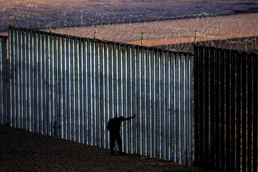 TIJUANA, BAJA CALIF. -- TUESDAY, NOVEMBER 20, 2018: The border wall is fortified with concertina wire at Playas Tijuana along the U.S. - Mexico border in Tijuana, Baja Calif., on Nov. 20, 2018. U.S. Customs and Border Protection hardened the wall with barbed wire in preparation for an increase of more people arriving with the migrant caravan. (Gary Coronado / Los Angeles Times)