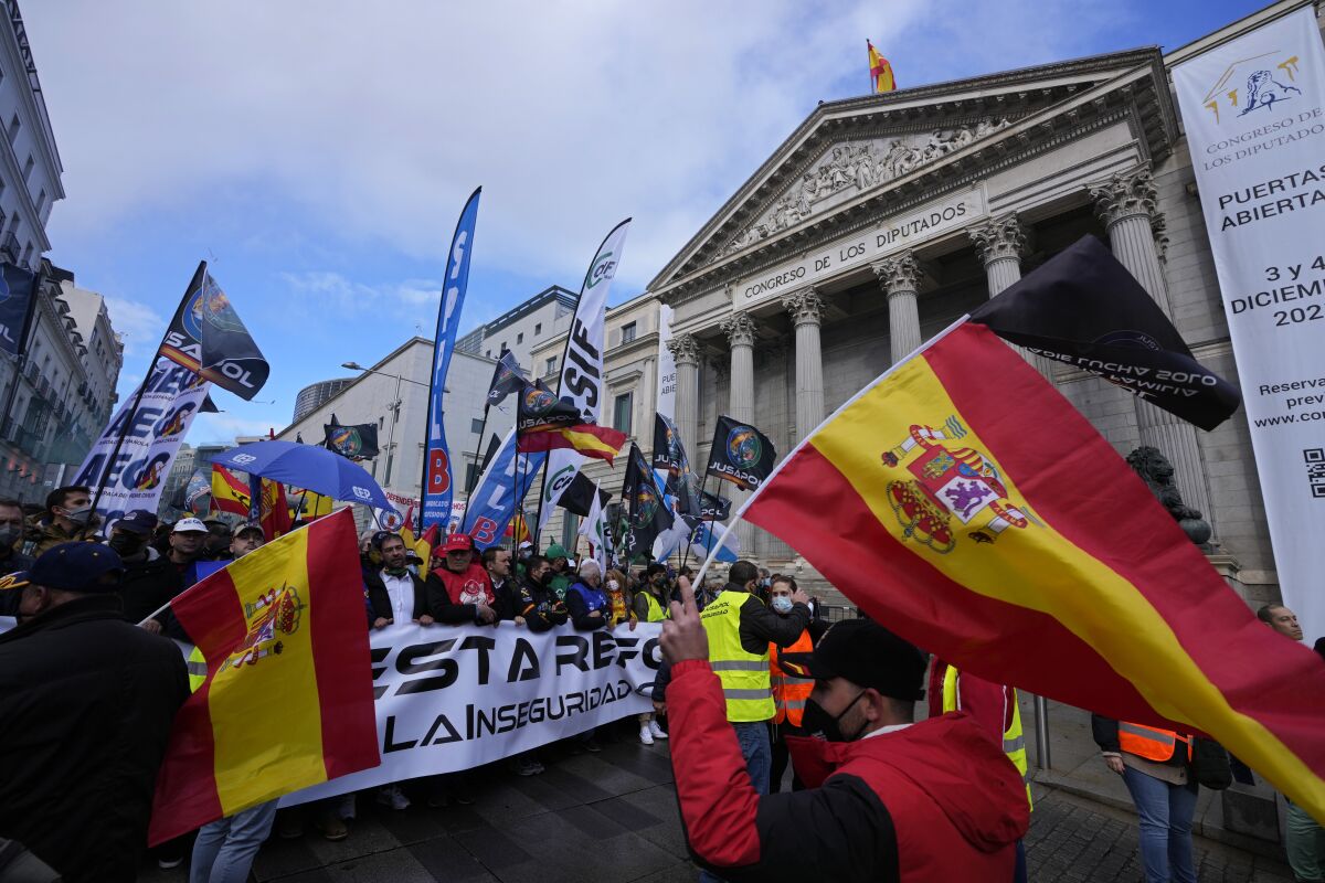 Police march past the Spanish parliament during a protest march in Madrid, Spain, Saturday, Nov. 27, 2021. Tens of thousands of Spanish police officers and their supporters rallied in Madrid on Saturday to protest against government plans to reform a controversial security law known by critics as the “gag law.” (AP Photo/Paul White)