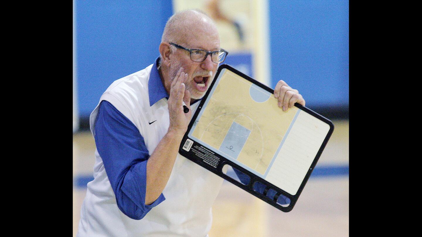 Burbank High girls' basketball head coach Bruce Breeden yells a play to his team in the closing seconds of their game against rival Burroughs High. Burroughs came back late to win, 43-41.
