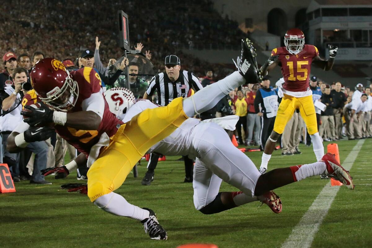 USC wide receiver Marqise Lee, left, hauls in a two-point conversion pass over Stanford's Jordan Richards during the first quarter of Saturday's game at the Coliseum.