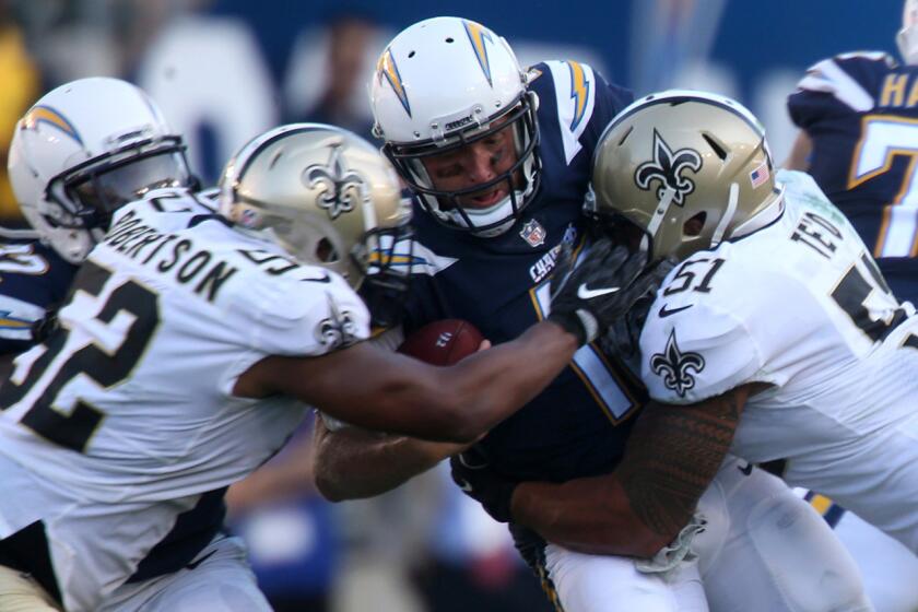 Chargers quarterback Kellen Clemens is sacked by Saints linebacker Manti Te'o, right, and linebacker Craig Robertson during second quarter action.