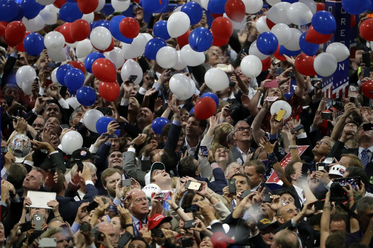 Confetti and balloons fall as delegates celebrate after Donald Trump's speech at the 2016 Republican National Convention.