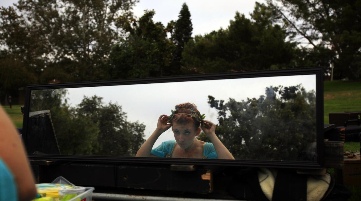 A reflection in a mirror as Olivia Schlueter-Corey prepares herself to play Hermia in "A Midsummer Night's Dream" by Shakespeare by the Sea in Polliwog Park in Manhattan Beach on Aug. 9, 2014.