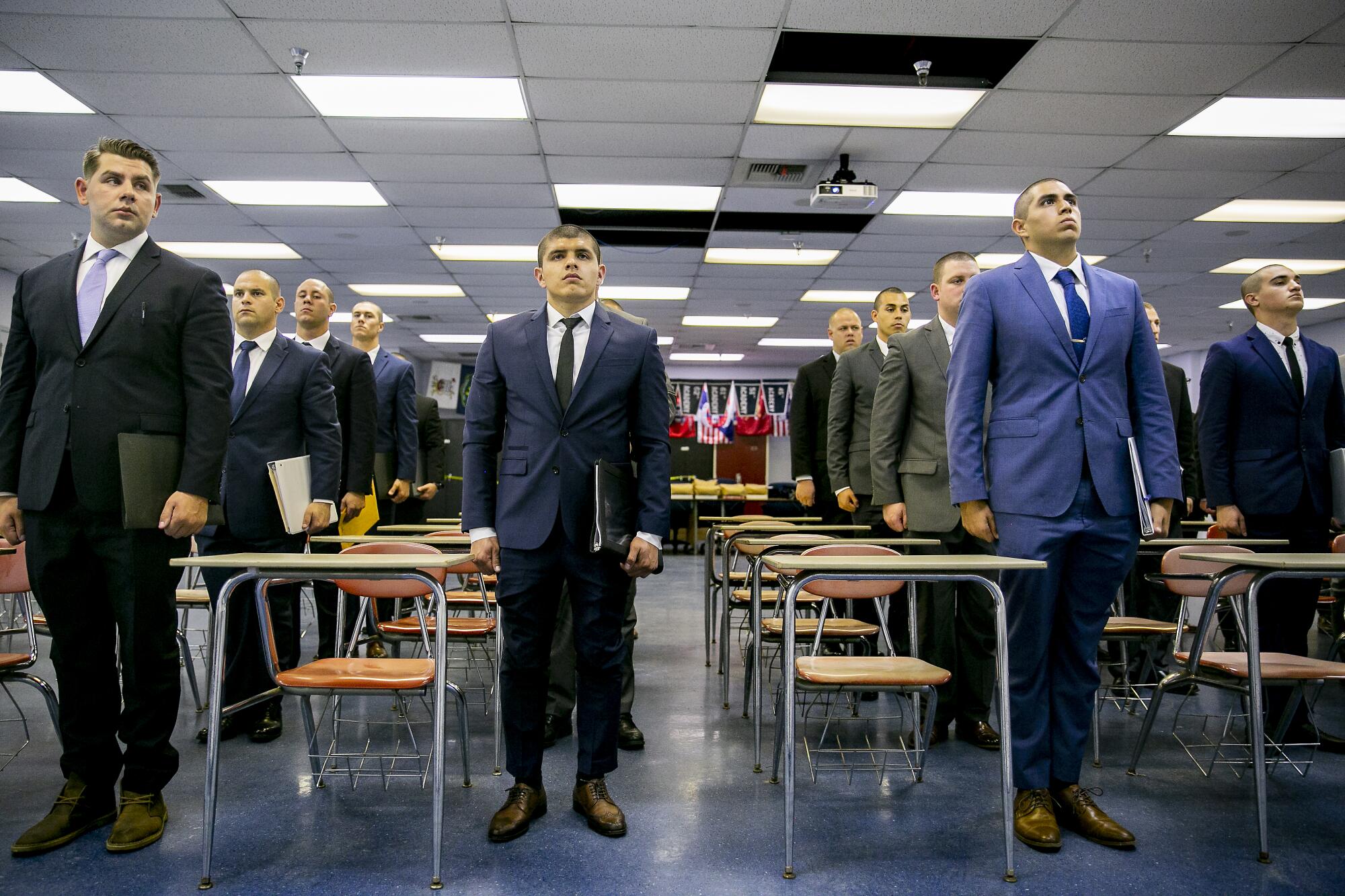 Costa Elizarraraz, center, stands at attention in the classroom alongside fellow recruits on orientation day for the 87th Academy.