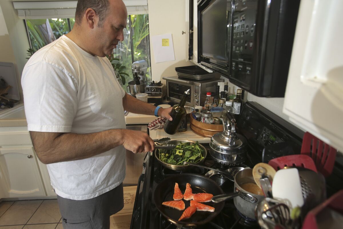 Aron Schwartz prepares a gourmet lunch for his children Max, 14, and Rhyan, 12.