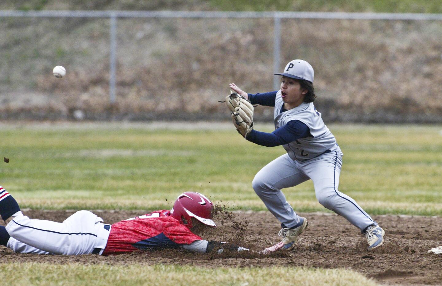 Avon runner Zack Aiello makes it back to 2nd in a pick-off attempt with Platt second baseman Peyton Theil. Platt plays Avon High School at Avon Tuesday. Michael McAndrews - Special to the Hartford Courant