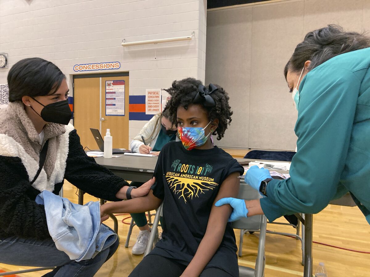 A student receives a vaccine.