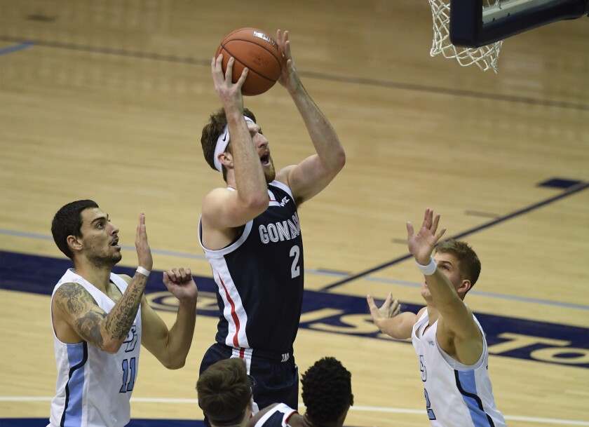 Gonzaga forward Drew Timme shoots past San Diego forward Yavuz Gultekin and guard Joey Calcaterra.
