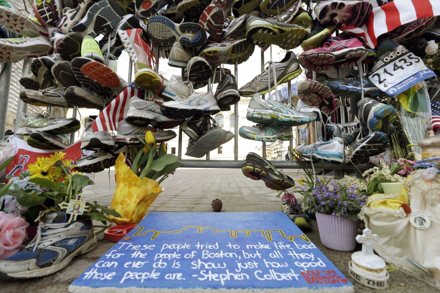 Running shoes and other items adorn a makeshift memorial to bombing victims near the Boston Marathon finish line in Boston's Copley Square, in an April 25, 2013, image.